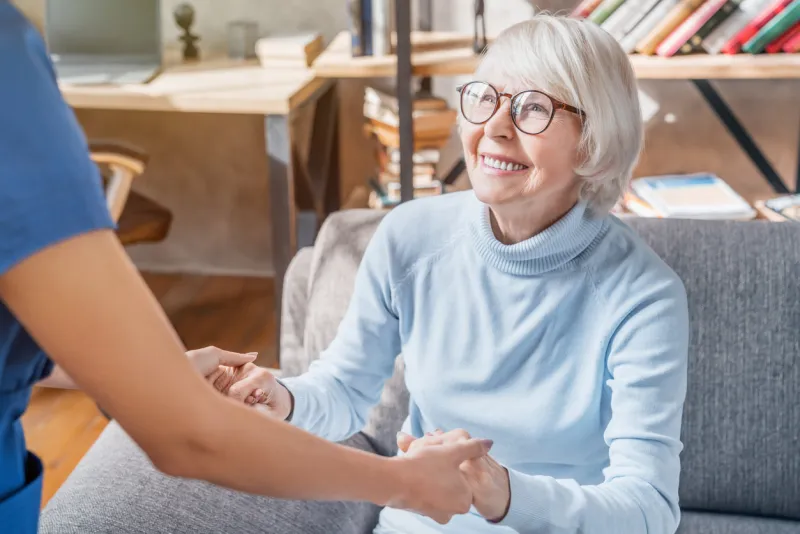 cropped image of female professional caregiver taking care of elderly woman at home cropped image of female professional caregiver taking care of elderly woman at home