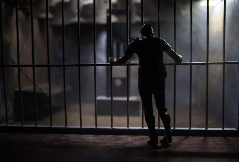 execution concept death penalty guillotine miniature inside old prison old prison bars cell lock man inside jail horror view of guillotine scale model in the dark execution concept death penalty guillotine miniature inside old prison old prison bars cell lock man inside jail horror view of guillotine scale model in the dark